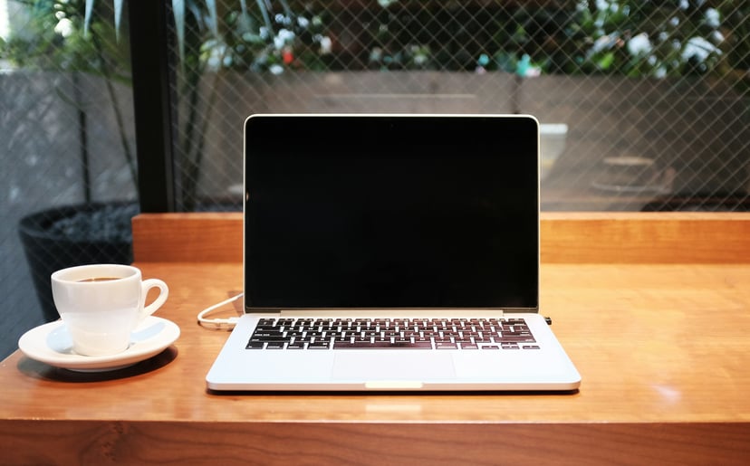 a laptop on a desk with a blank screen