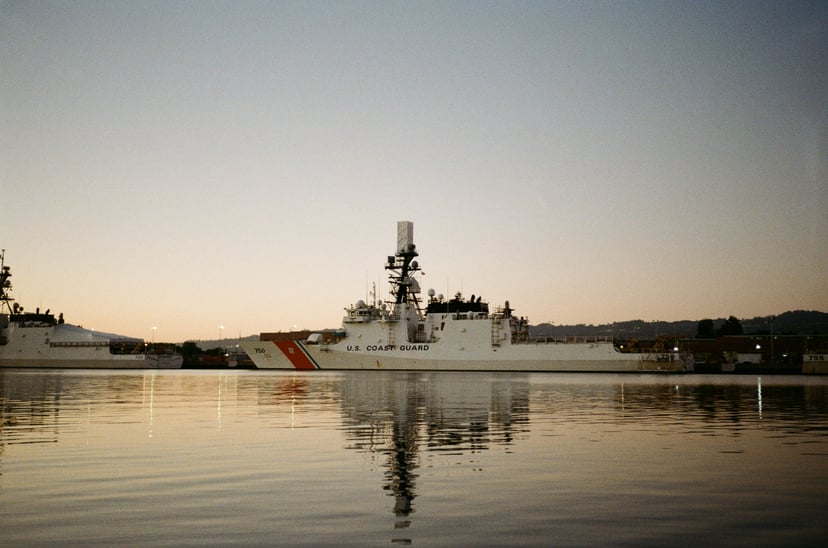 A U.S. Cost Guard vessel on the water at sundown