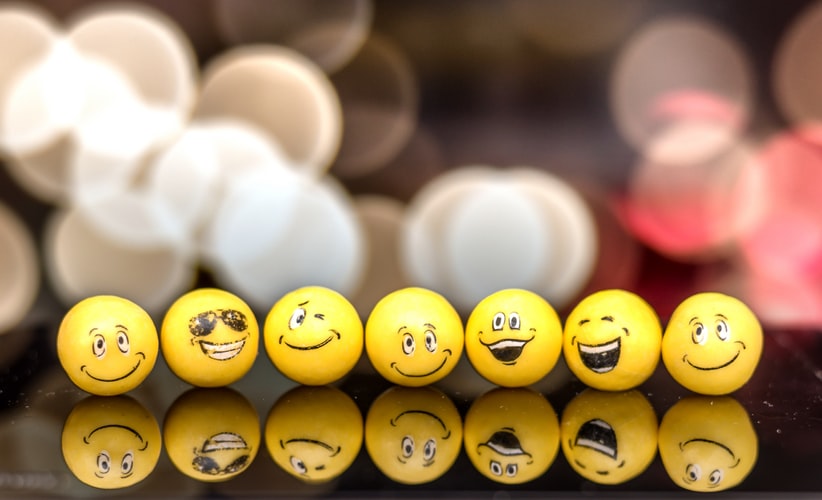 Yellow balls with various smiling and laughing faces on them