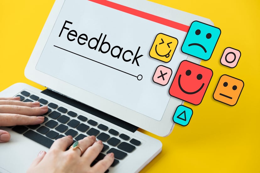 a laptop with the word 'feedback' on the screen