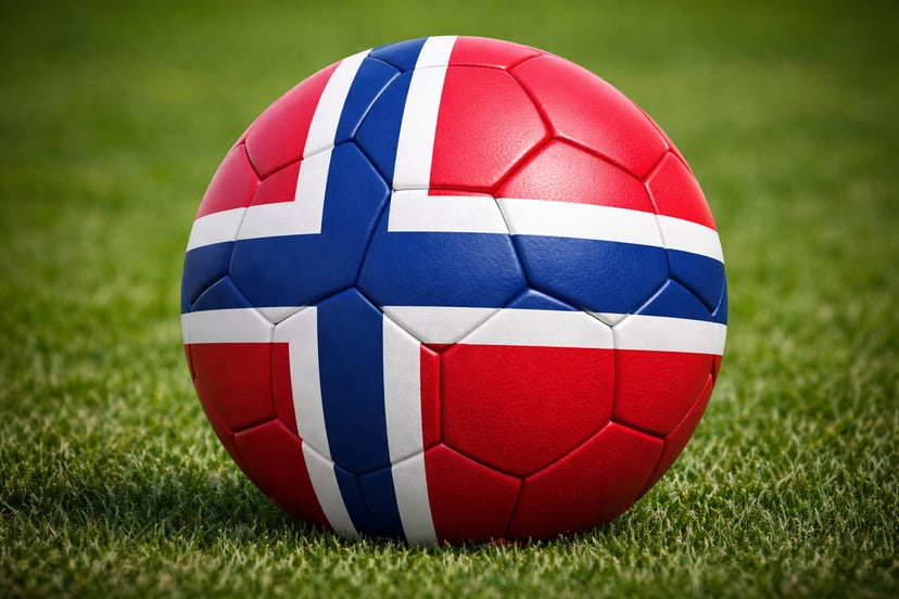A football with the Norwegian flag on it sitting on a football pitch
