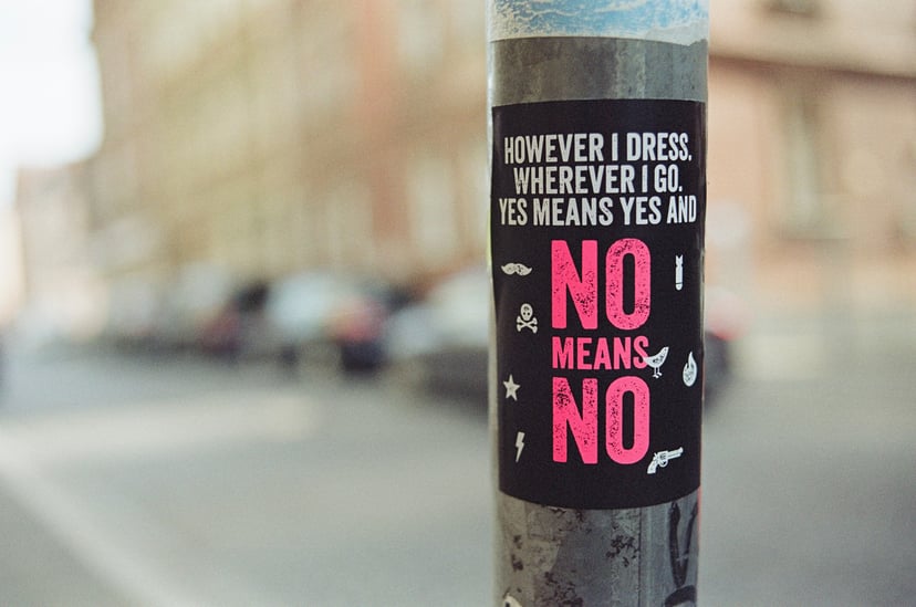 A sticker on a post saying 'no means no'