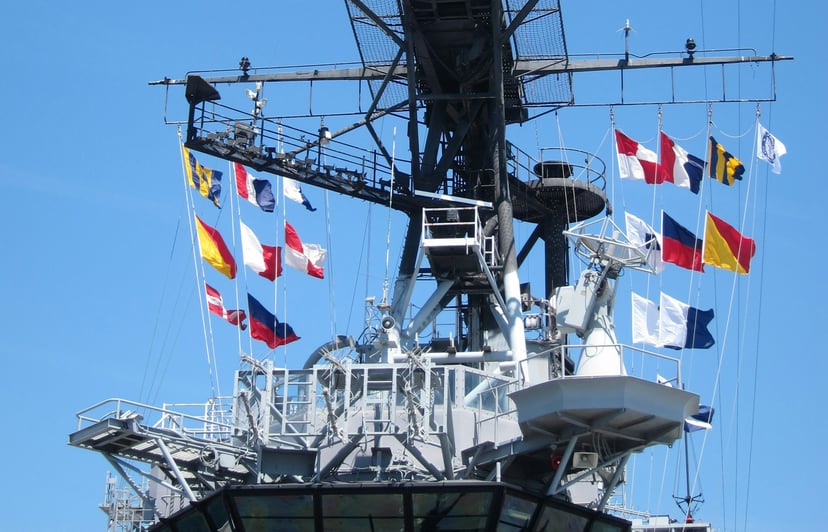 Nautical flags flying from the rigging of a vessel