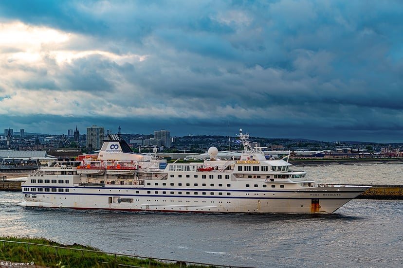 an expedition ship setting sail from a port