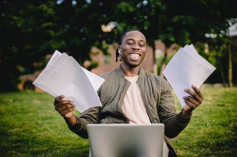 smiling man looking at a laptop