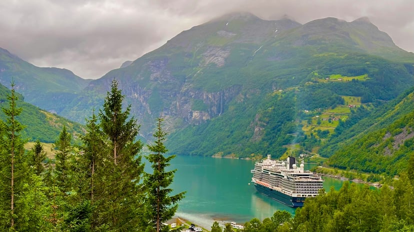 A cruise ship sailing through the Norwegian fjords