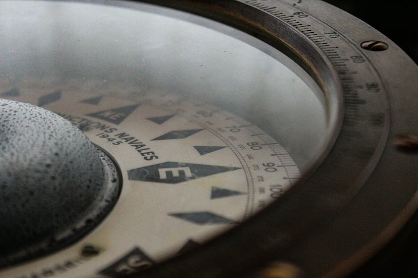a close up of a nautical compass