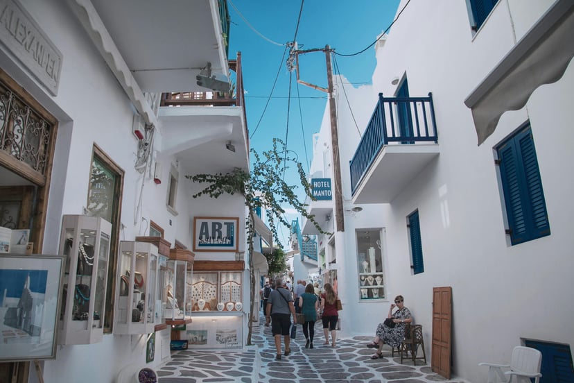 Tourists walking through the streets of Mykonos town, Greece