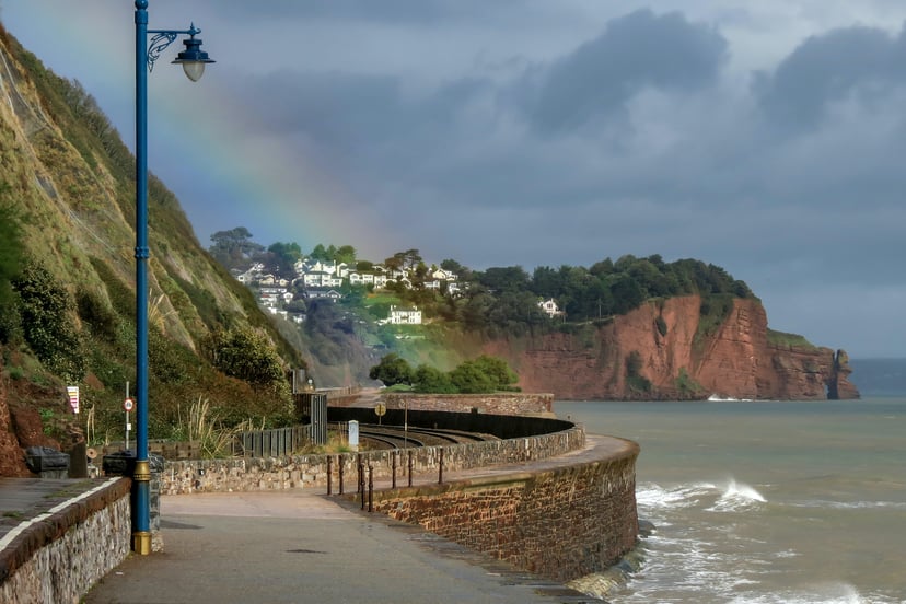 The coastal path at Teignmouth, Devon with a rainbow in the background