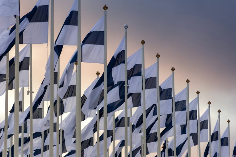 A row of Finnish flags raised to full mast