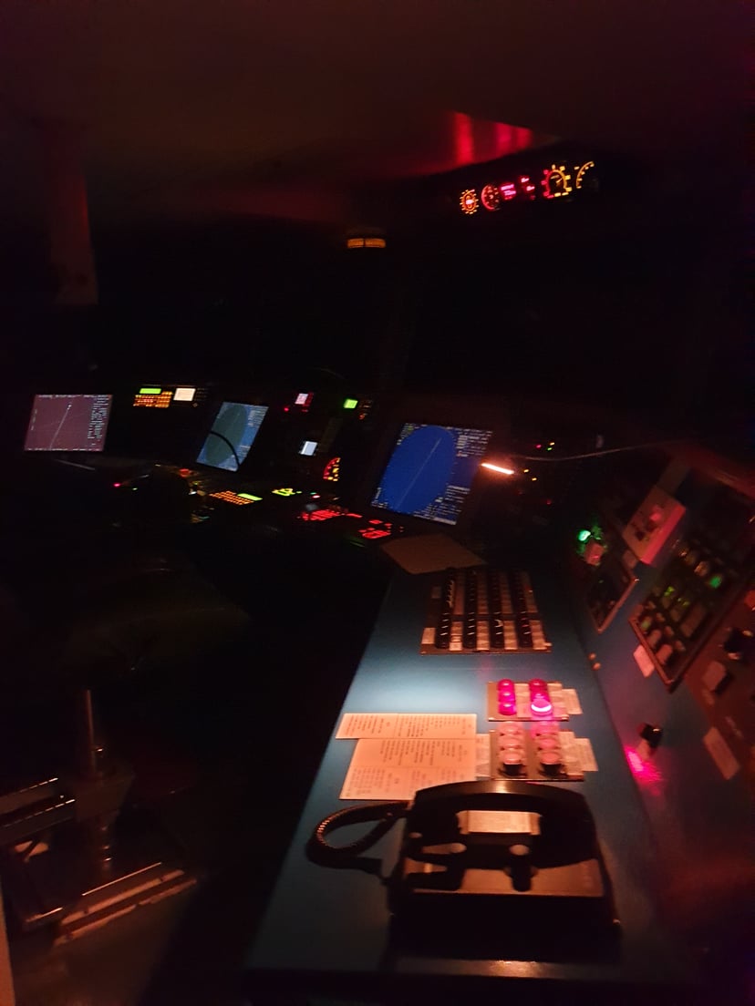 the bridge of a cargo ship at night