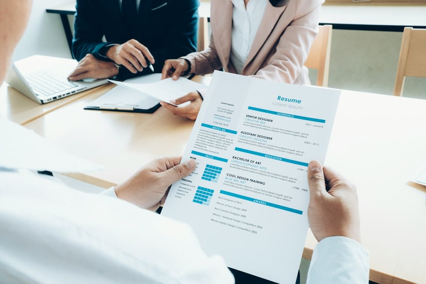 hands holing a paper resume 