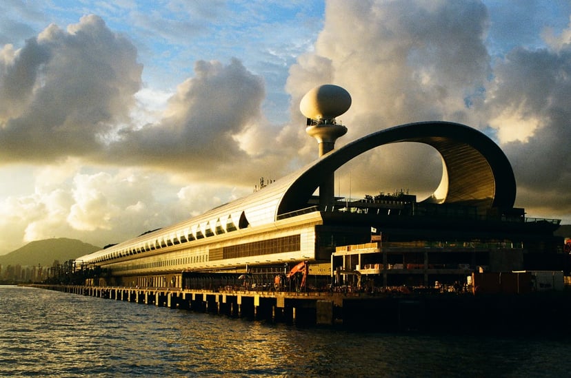 Kai Tak cruise terminal in Hong Kong under a cloudy sky at Golden Hour