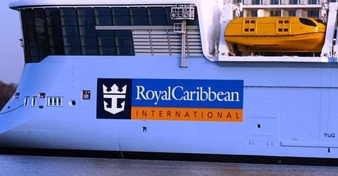 The Royal Caribbean International logo on the hull of one of its cruise ships