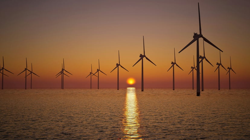 An offshore wind farm at sunset