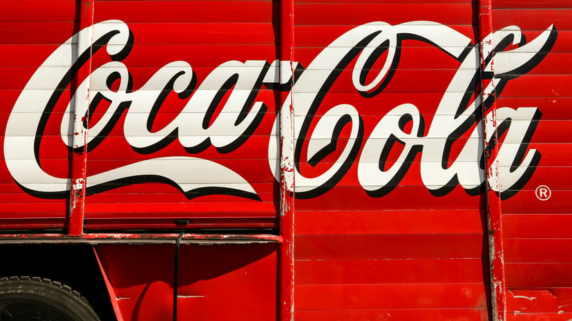 the Coca Cola log painted on the side of a truck
