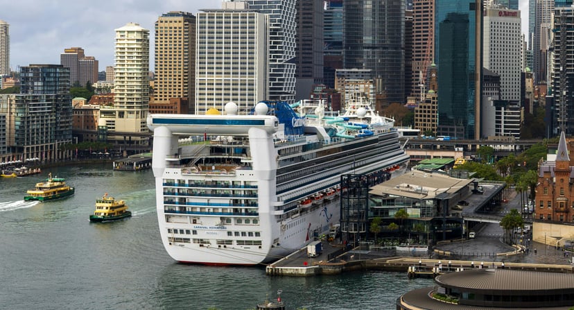 The Carnival Adventure cruise ship docked in a city port