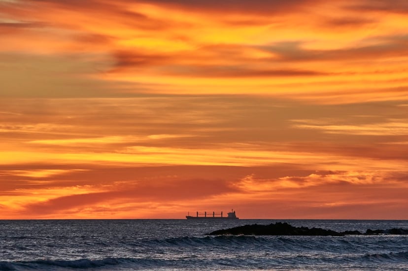 Silhouette of a bulk carrier at sunset