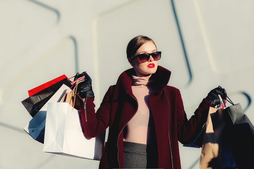 A chic woman holding lots of shopping bags