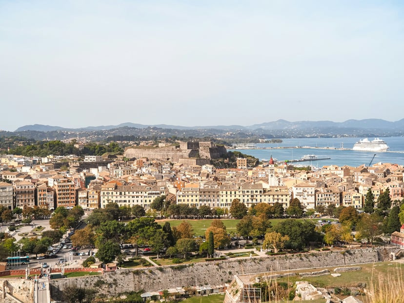 Corfu island with an unidentified cruise ship sailing out of a port
