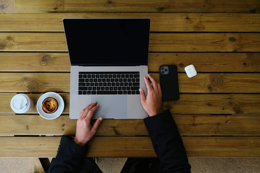 a laptop with a blank screen on a wooden desk