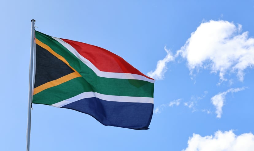 The flag of South Africa flying against a blue sky