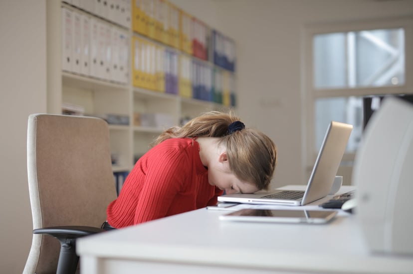 woman-with-head-on-her-desk.jpeg