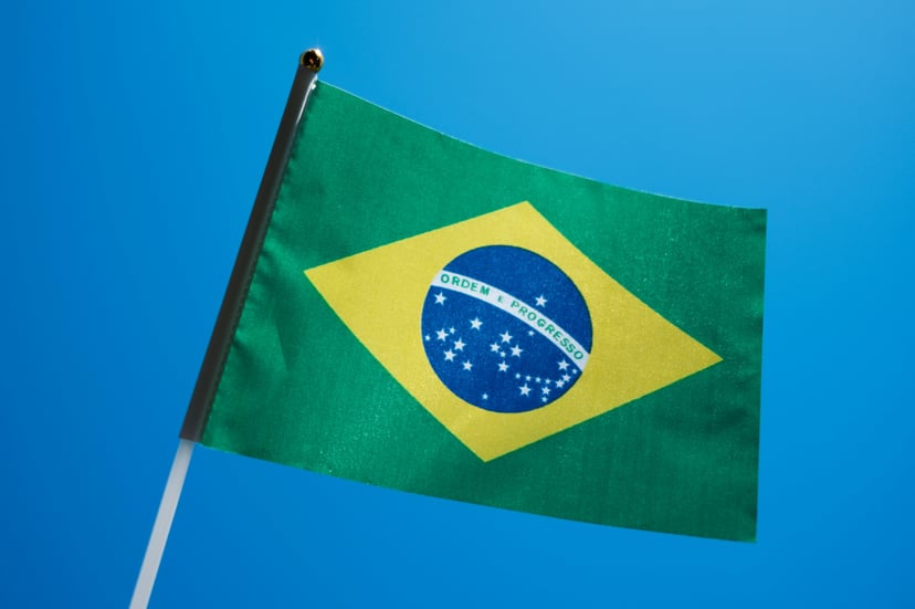The flag of Brazil against a blue background