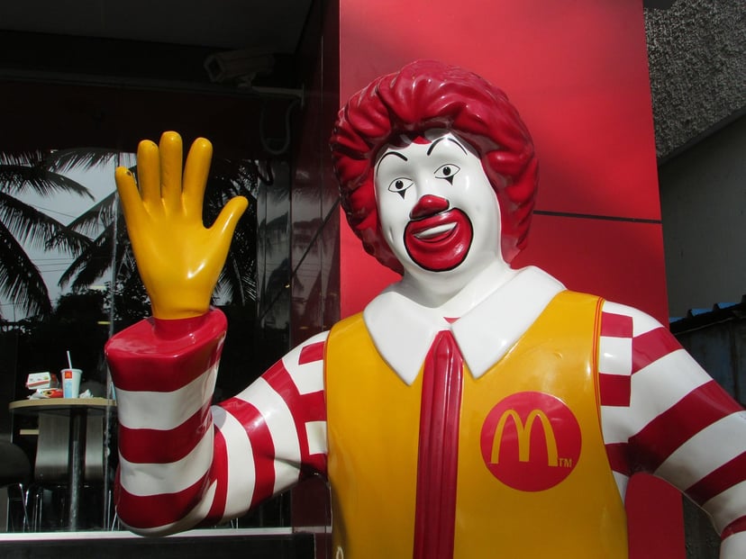 A waving Ronald McDonald statue