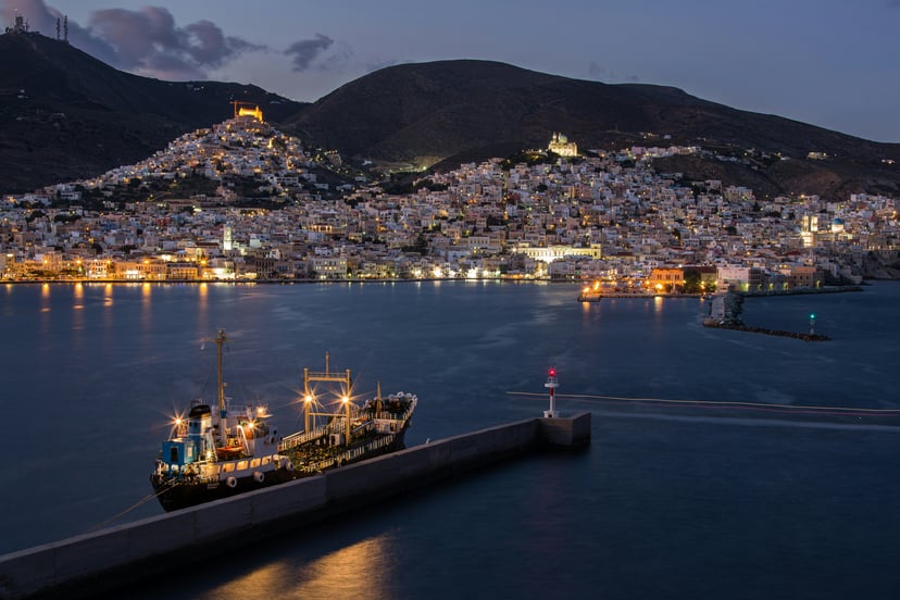 Syros Port at dusk with brightly lit buildings