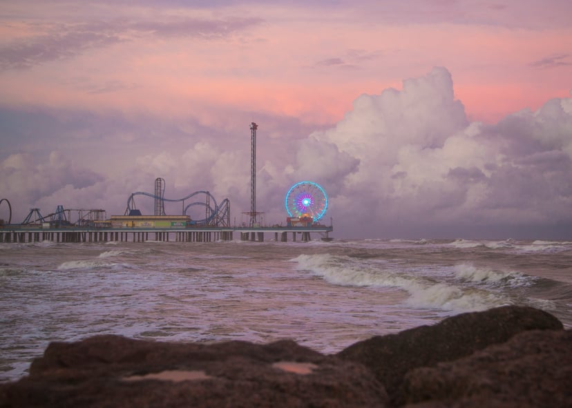 Galveston Pier, Texas under a pink cloudy sky