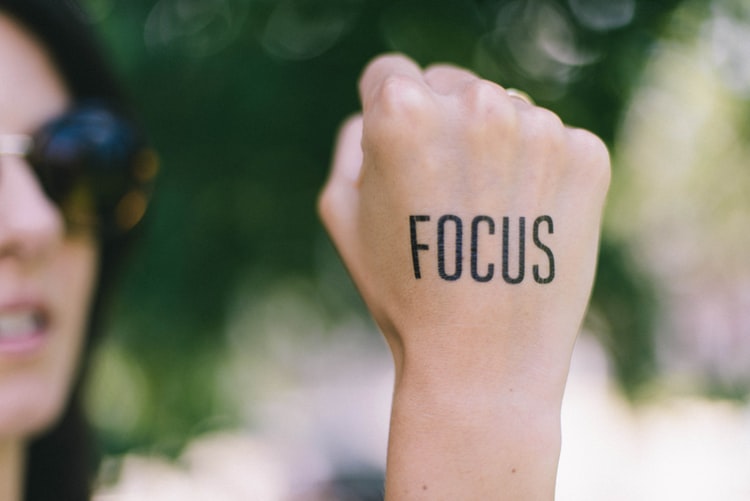 a hand with focus written on it 