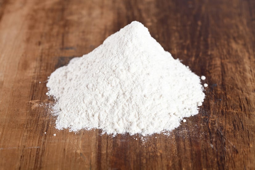 A pile of white powder on a wooden surface