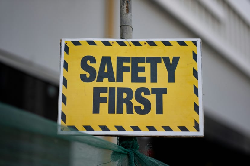 a yellow and black sign saying 'Safety First'