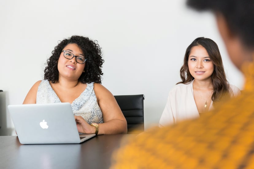 two women interviewing a person for a job 