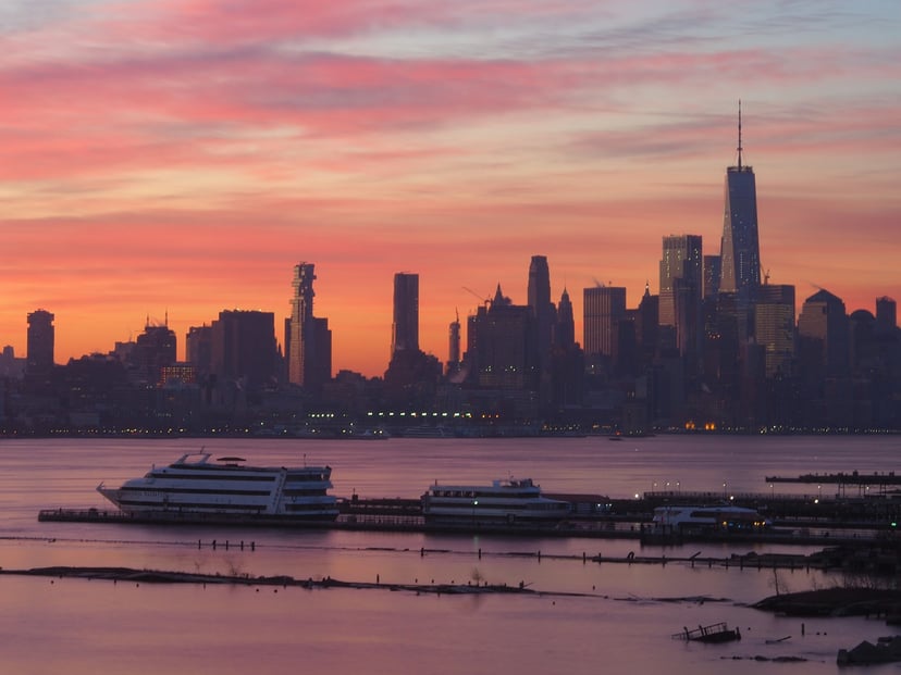Cruise boats on the Hudson River in NYC at sunset