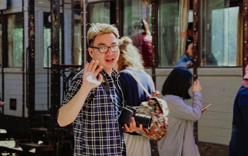 man waving goodbye to the camera