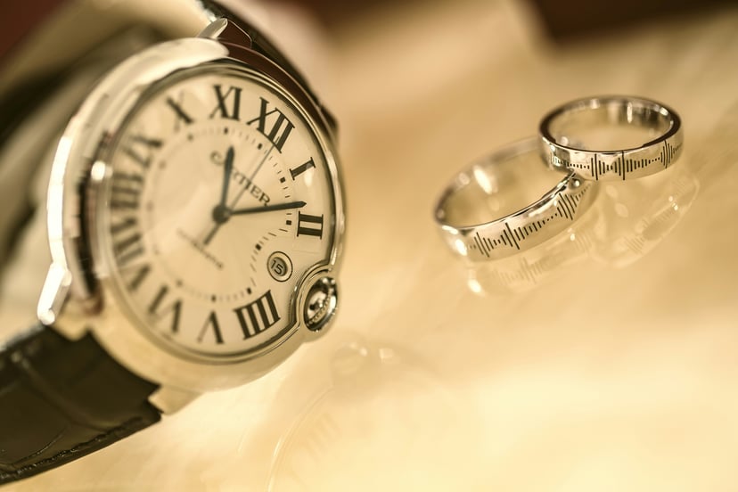 A Cartier watch and two silver rings