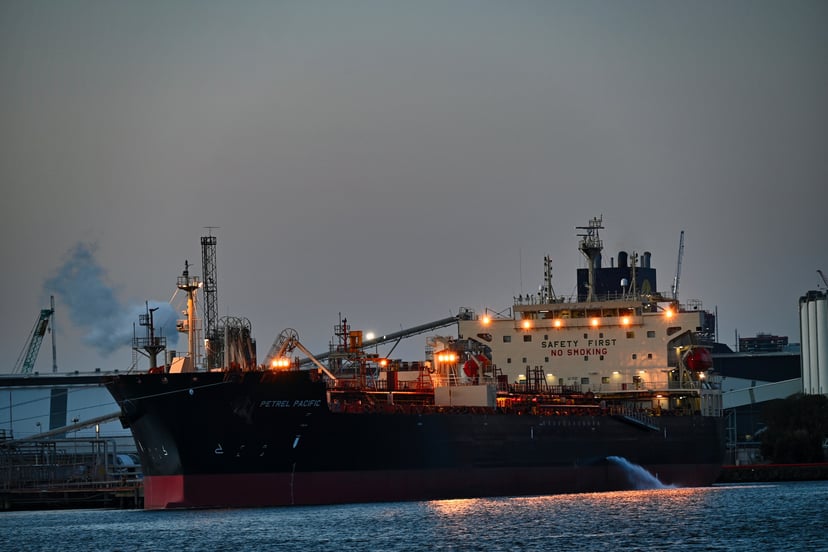 A cargo ship in a port in the evening