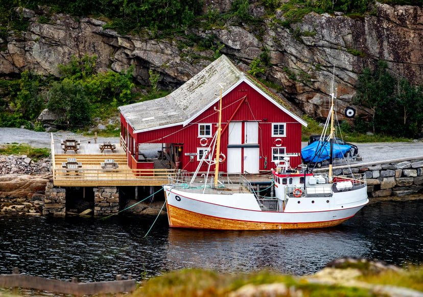 A boat and traditional wooden house in Bessaker, Norway