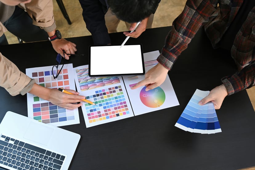 a group of people trying to decide on colors for a brand logo