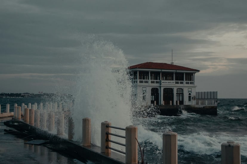 waves crashing against a boat house