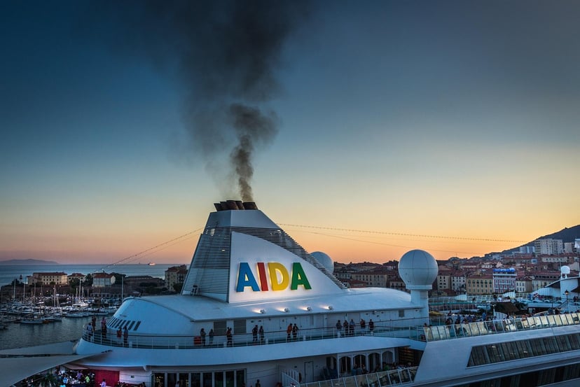 An AIDA cruise ship at sunset in a port