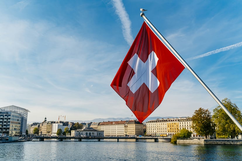 The Swiss flag flying in front of buildings in Geneva
