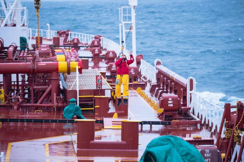 Seafarers working on the deck of a commercial vessel
