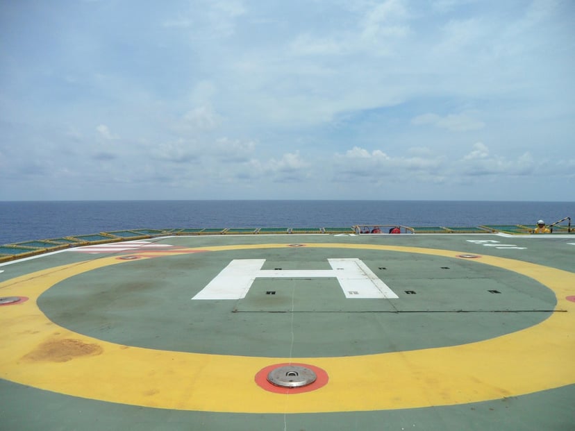 A helipad with a view of the ocean in the background