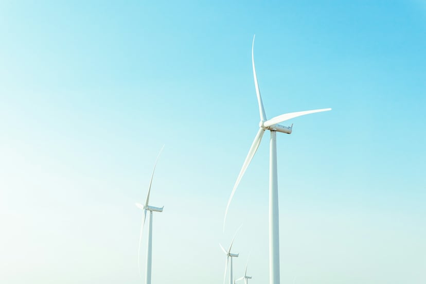 An offshore wind farm against a blue sky