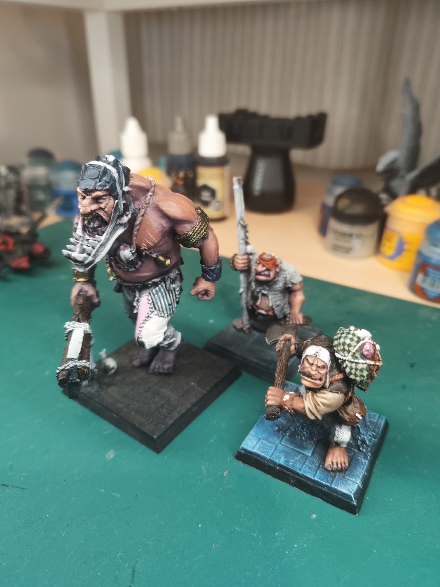 An old world giant, and two ogres half painted.