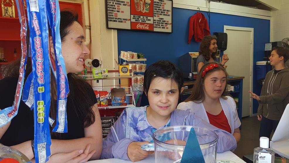 Sierra Repp, Anahita Wang and Zahra Detweiler work the Snack Shop at a Little League game.
