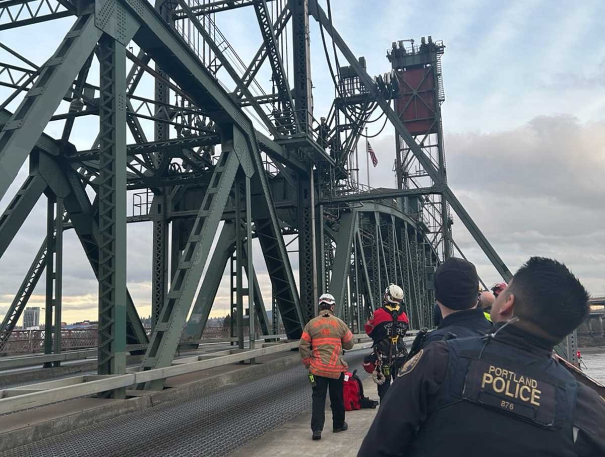 Police officer looks up at Hawthorne Bridge